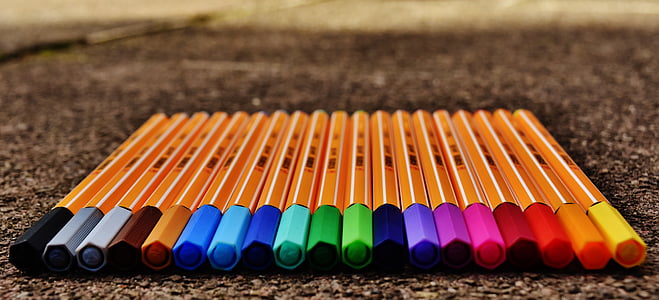 assorted-color color pen lot on black surface thumbnail