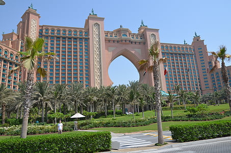pink and blue building besides trees at daytime thumbnail
