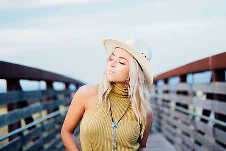 blonde haired woman in brown sleeveless top on bridge in fashion photography thumbnail