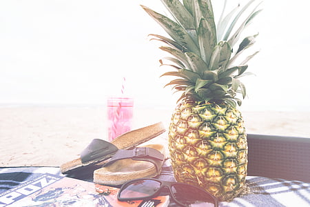 green pineapple beside of black sunglasses thumbnail