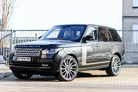 gray Land Rover Range Rover SUV parked near gray building thumbnail