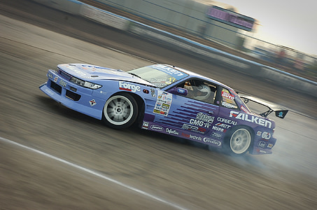 blue and purple vehicle on race track thumbnail