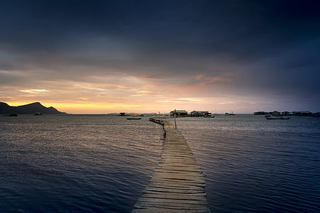 brown wooden dock surrounded with body of water thumbnail