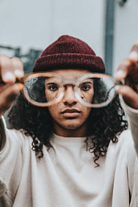 man holding eyeglasses thumbnail