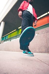 low angle photo of man walking near wall thumbnail