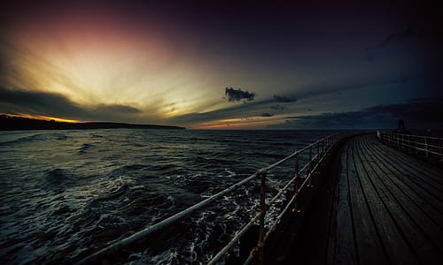 dock near water with light rays thumbnail