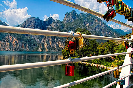 gold and red padlocks hanging on fence thumbnail