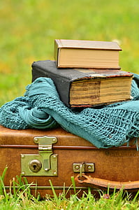 selective focus photography of two books on leather suitcase thumbnail