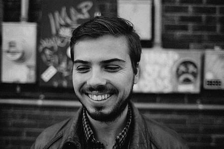 man smiling near concrete building thumbnail