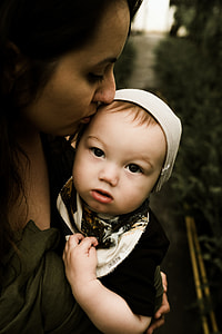 woman carrying baby thumbnail