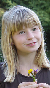 smiling girl holding flower thumbnail