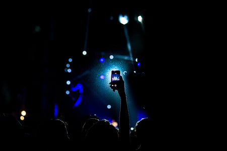 person taking a video of concert thumbnail