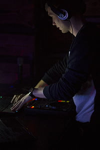 DJ wearing headphones while mixing thumbnail