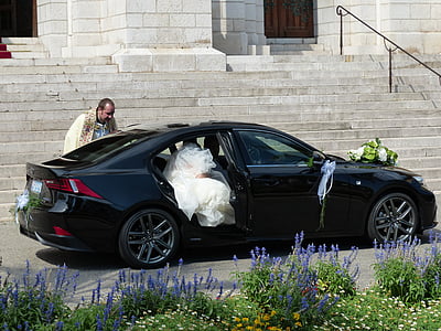 woman wearing wedding dress getting out of black sedan at daytime thumbnail