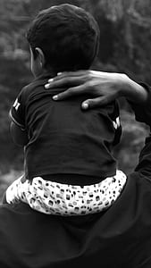 grayscale photo of baby sitting on shoulder thumbnail