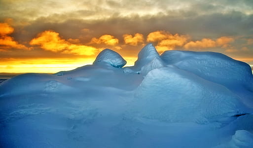 ground covered with snow during golden hour photo thumbnail