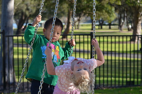 two toddler's riding on swing thumbnail