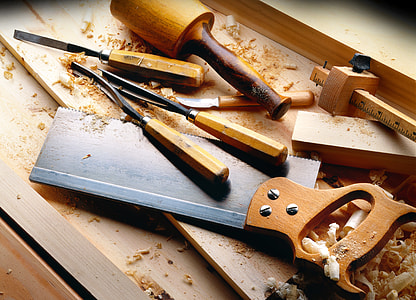 assorted handheld tools on brown wooden surface thumbnail