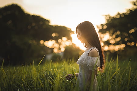 standing woman surrounded by plants during daytime thumbnail