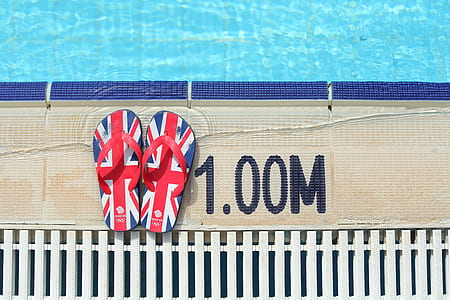 pair of red-and-blue flip-flops beside poo thumbnail
