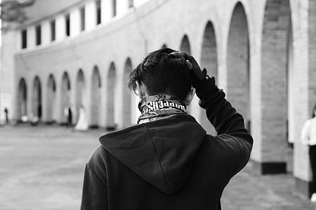 grayscale photography of man wearing hoodie thumbnail