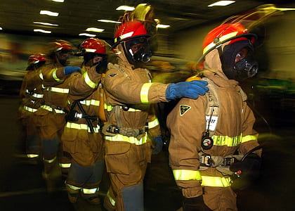 five firefighters walking straight inside building thumbnail