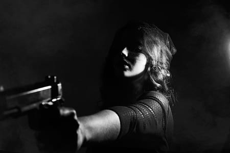 grayscale photo of person holding pistol thumbnail