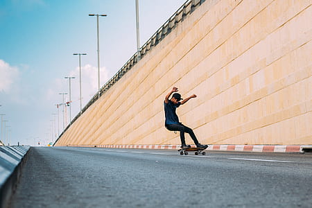 man riding skateboard on road at daytime thumbnail