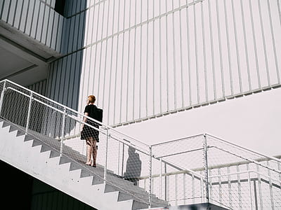 woman walking on white staircase thumbnail