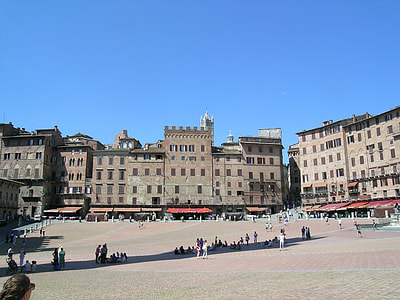 people standing and sitting outside building at daytime thumbnail