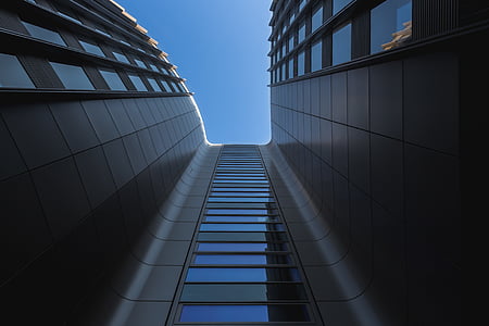 low-angle photography of gray buildings under blue sky thumbnail