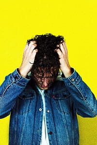 person in denim jacket scratching his hair thumbnail