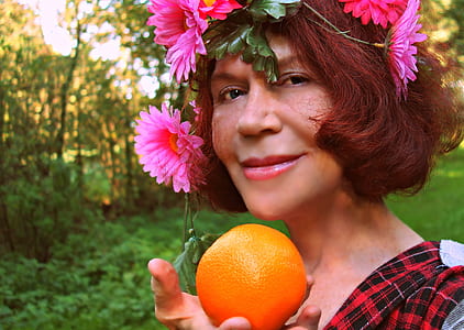 woman holding orange fruit thumbnail