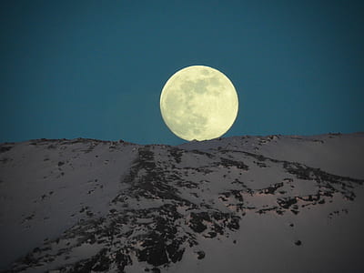 full moon over snow covered mountain thumbnail