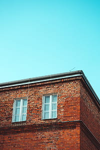 brown concrete building under blue sky thumbnail