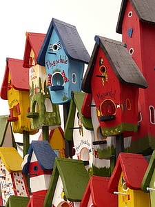 selective focus photo of assorted-color wooden birdhouses thumbnail
