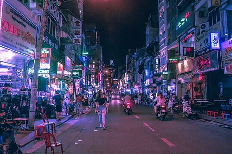 woman walking in the middle of the road during nighttime thumbnail