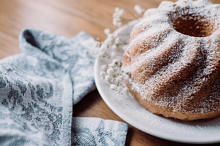 closeup photo of baked bread with white sugar on white saucer thumbnail