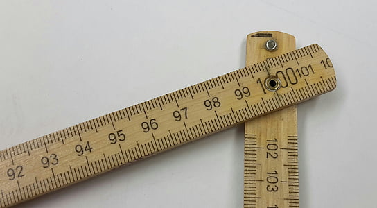two brown measuring sticks on white surface thumbnail