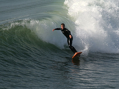 man surfing on sea water during daytime thumbnail