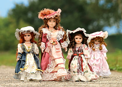 four female dolls in pink and blue dresses thumbnail
