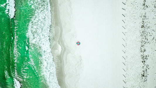 aerial photo of sand beside large body of water thumbnail