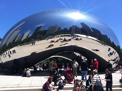 group of people in standing in front of silver structure thumbnail