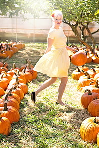 woman holding pumpkin while smiling thumbnail
