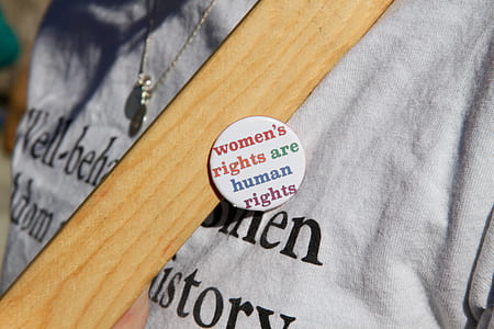 person wearing white women's rights are human rights pin-back buttons thumbnail