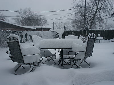 Black Patio Table and Chairs Covered of Snow thumbnail