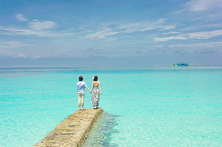two people standing near sea thumbnail
