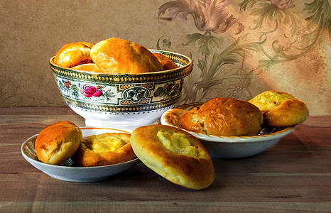 breads in white ceramic bowls on brown wooden surface thumbnail