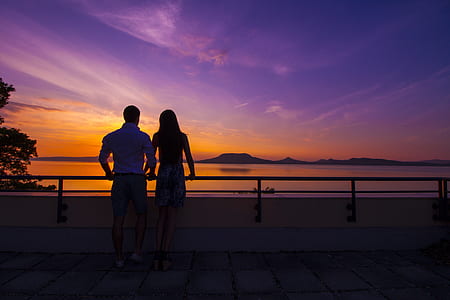 silhouette of man and woman holding a bar thumbnail