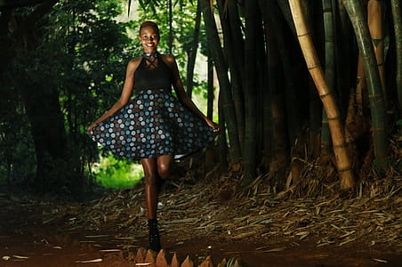Woman Smiling While Holding Her Blue Polka Dots Skirt thumbnail